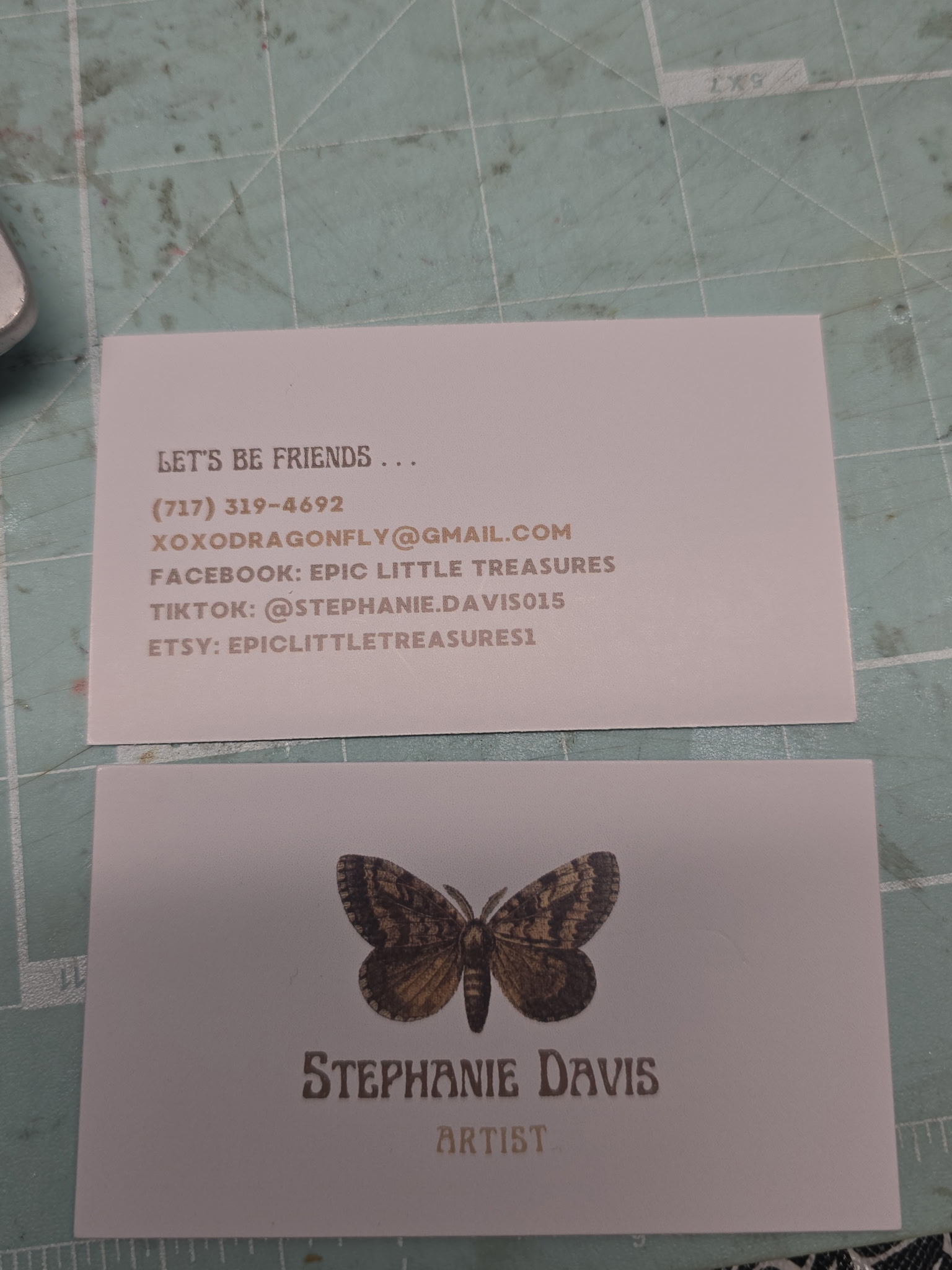 Epic Little Treasures business card with the vintage moth emblem and Stephanie Davis, Artist